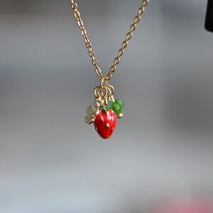 Brand new tiny 18k gold strawberry necklace